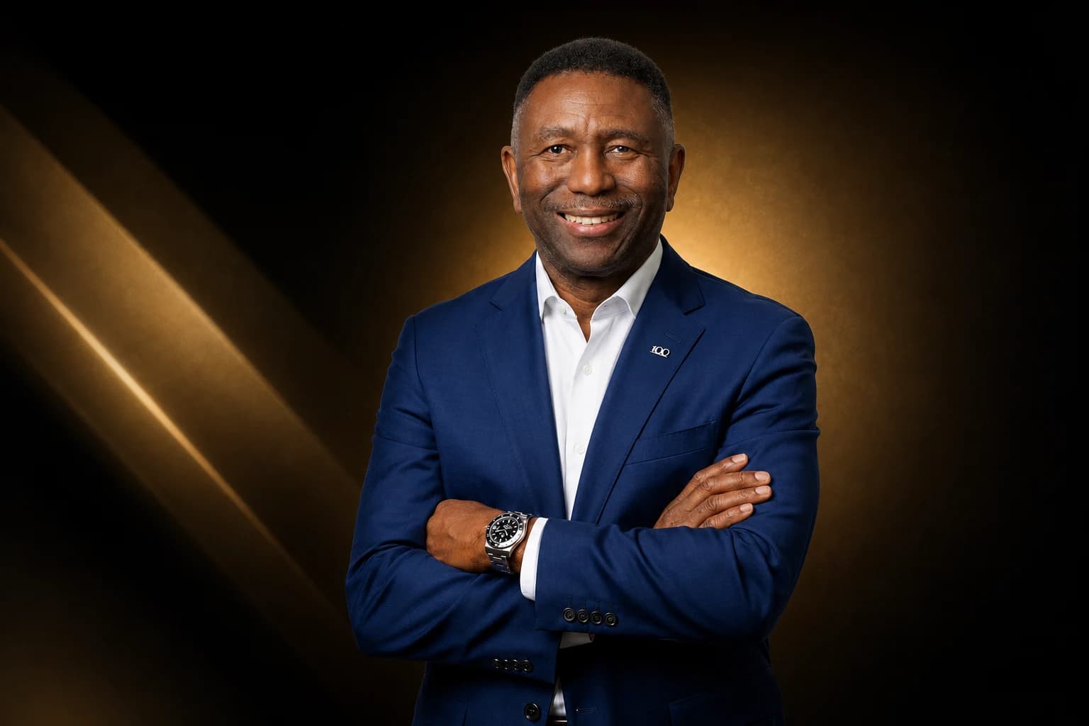 Charles Griggs in a blue suit against a black and gold background